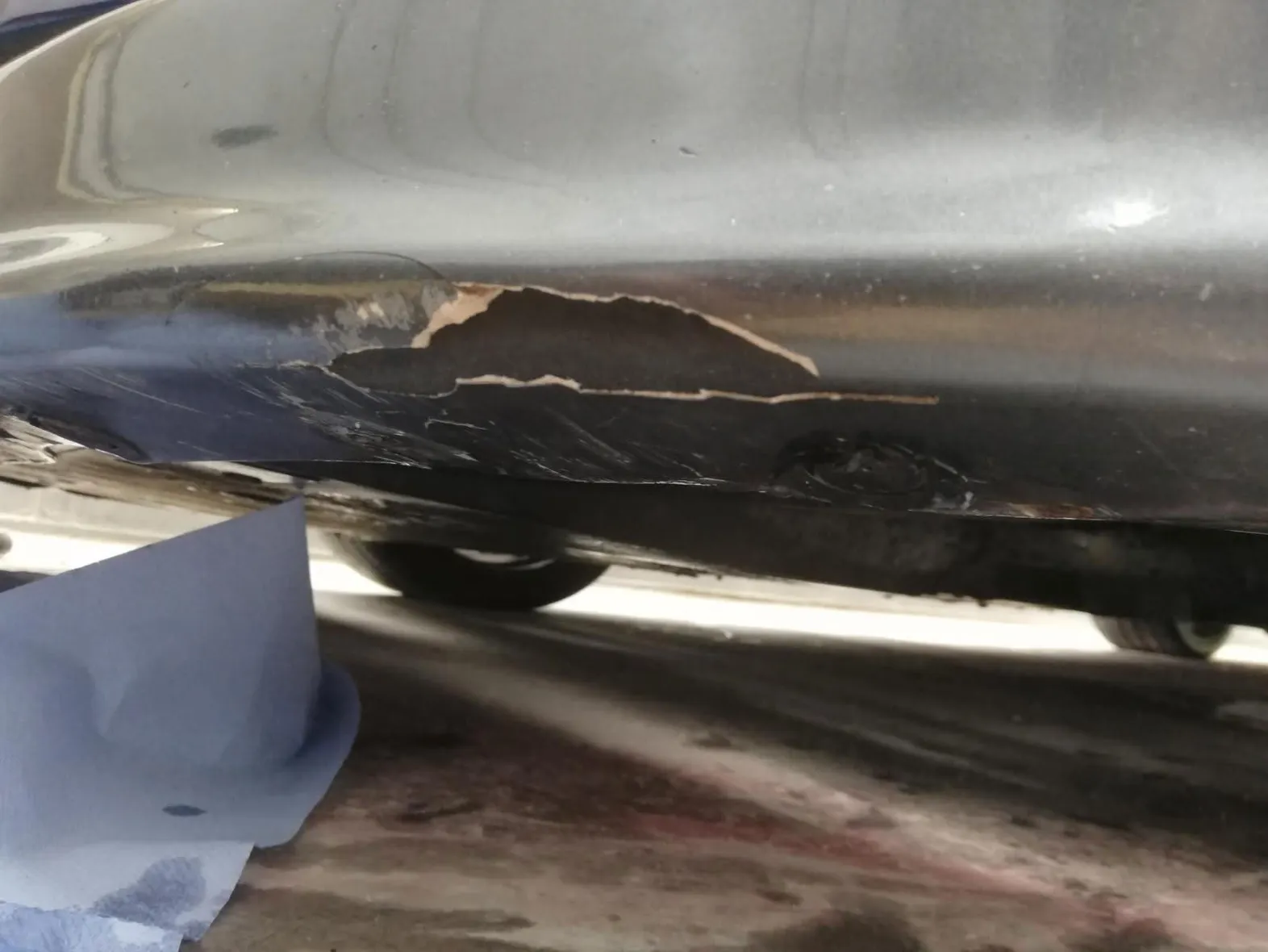 Car bumper before repair, scuffed and scratched
